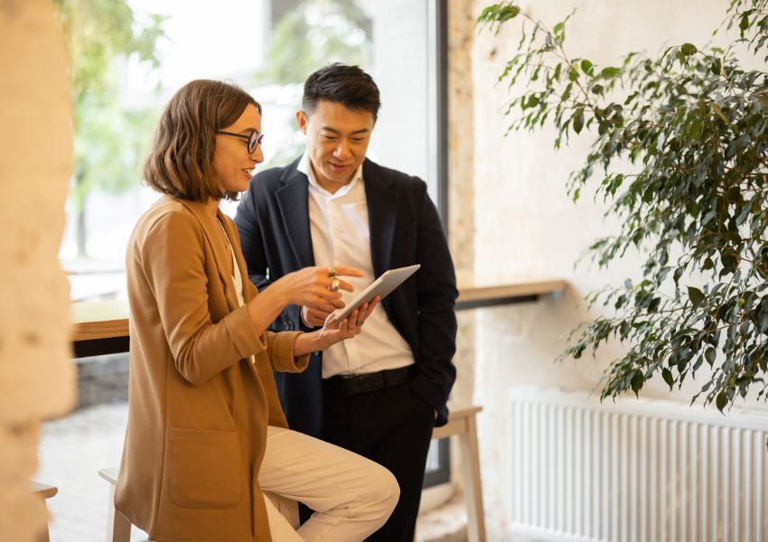 two-people-looking-at-tablet-with-a-table