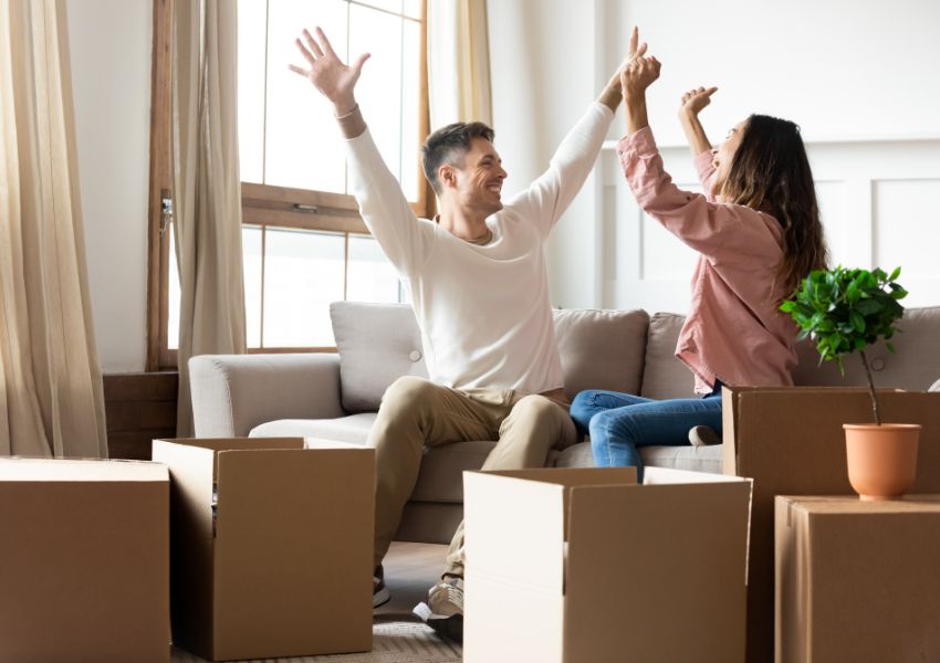 two-happy-people-with-boxes-on-couch